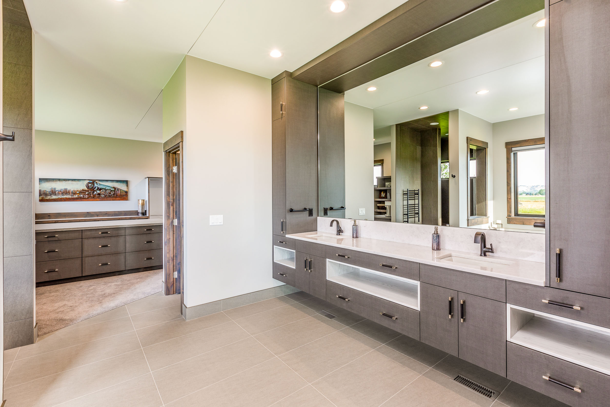 Large master bathroom with double sinks designed by Ban Construction